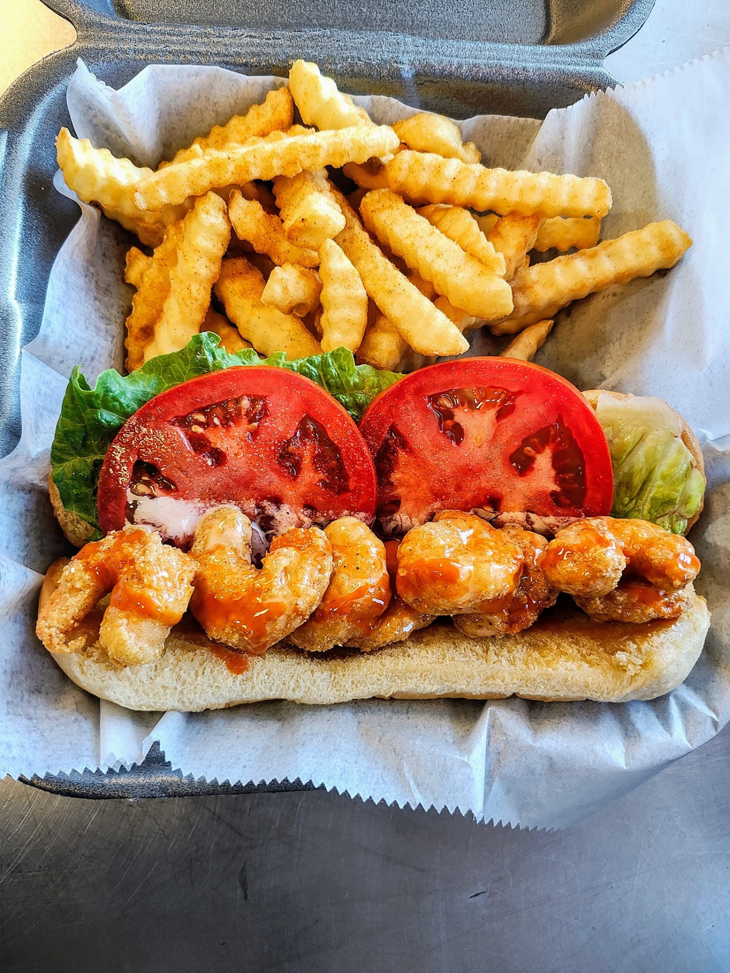 Crispy fried shrimp po' boy with crinkle-cut fries from the WTF food truck